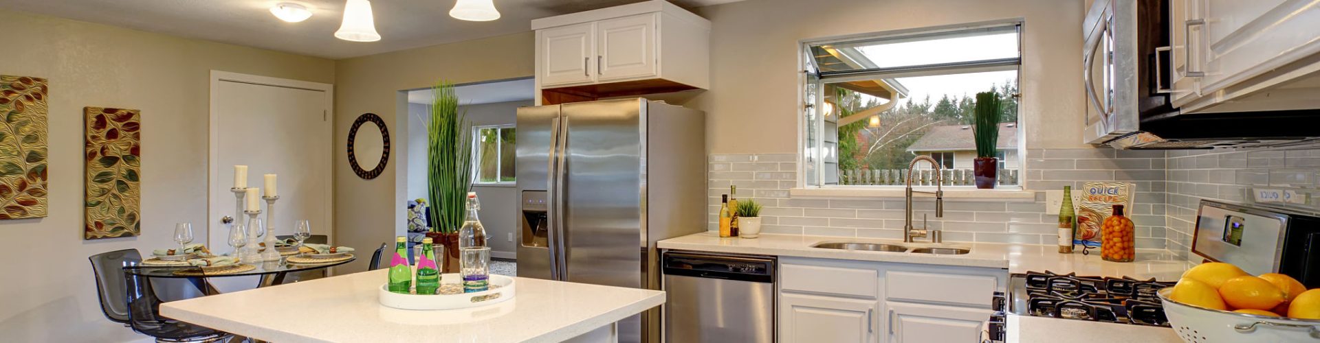 Nice kitchen in modern home including island and white counter tops.